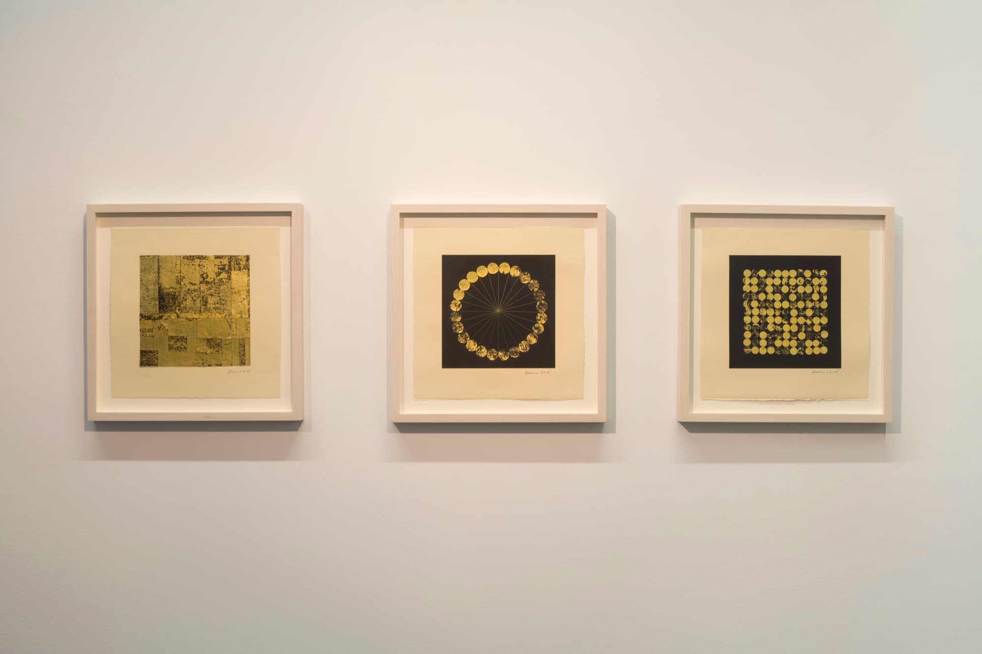 Installation view of Life Lines in Paris, with three framed black-and-gold works arranged across a white gallery wall