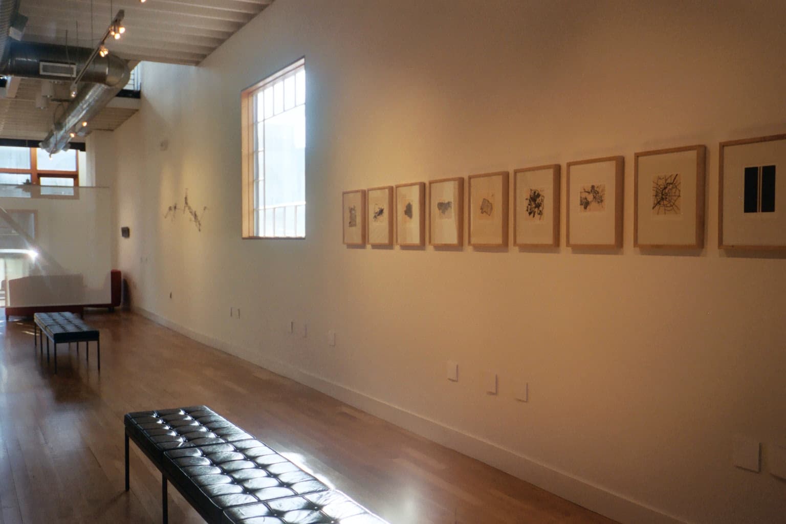 Installation view of Maps, Homes and Itineraries at Gallery Lux, with framed city maps and line-based wall works