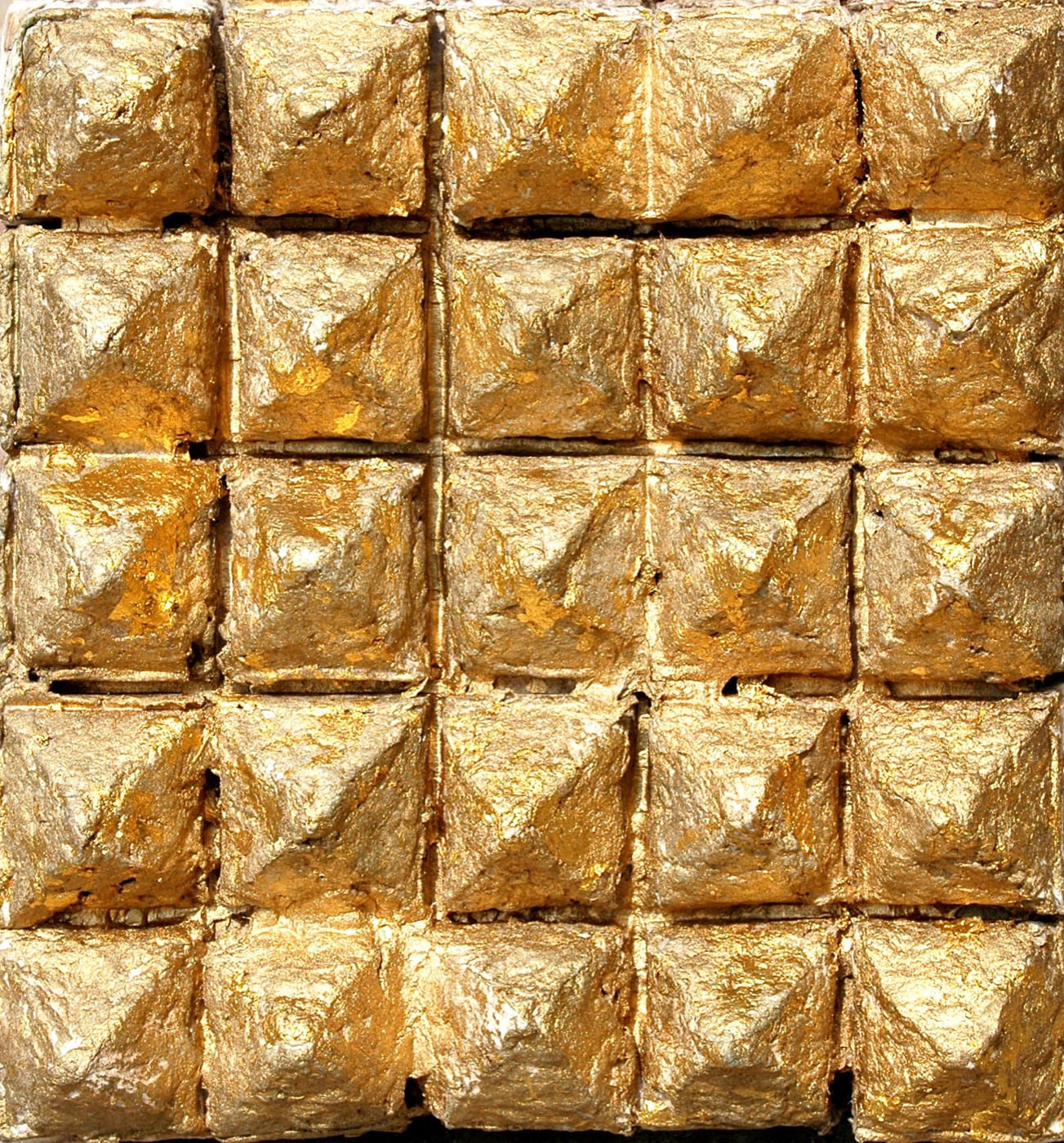 Roofs, a gridded cast-paper sculpture covered with gold leaf, by Zarina