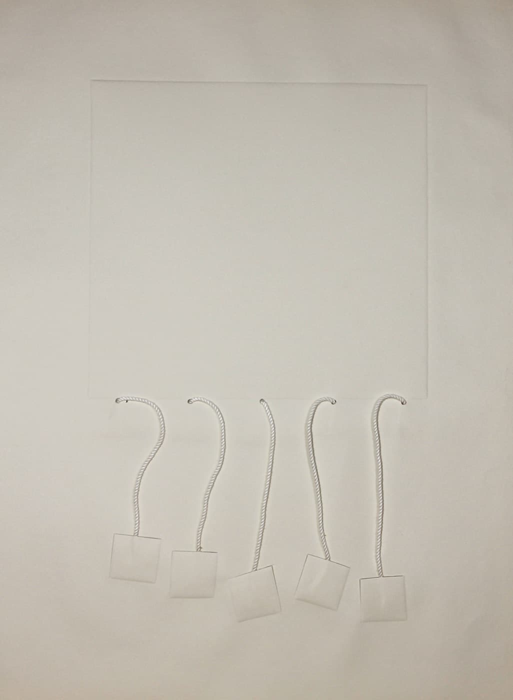 Untitled, 1974, a nearly white embossed sheet with five lengths of silk cord and small suspended squares