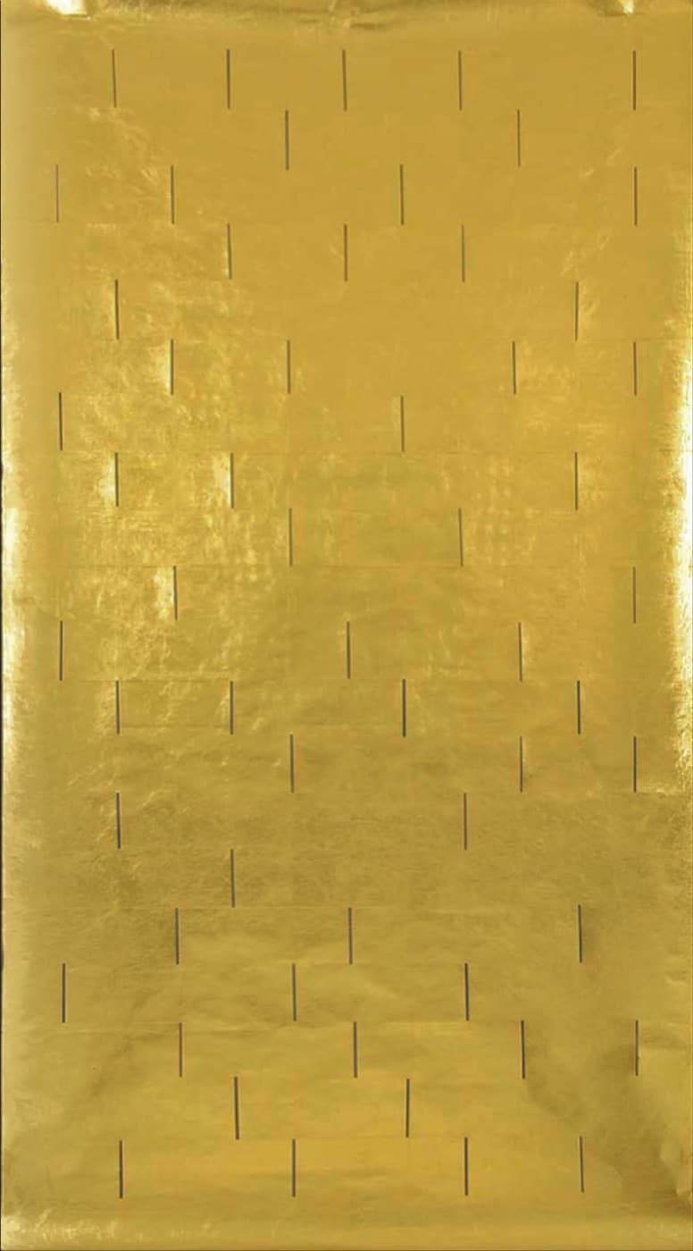 Blinding Light, 2012, Zarina’s tall gold-leaf sheet pierced by a measured field of narrow vertical openings